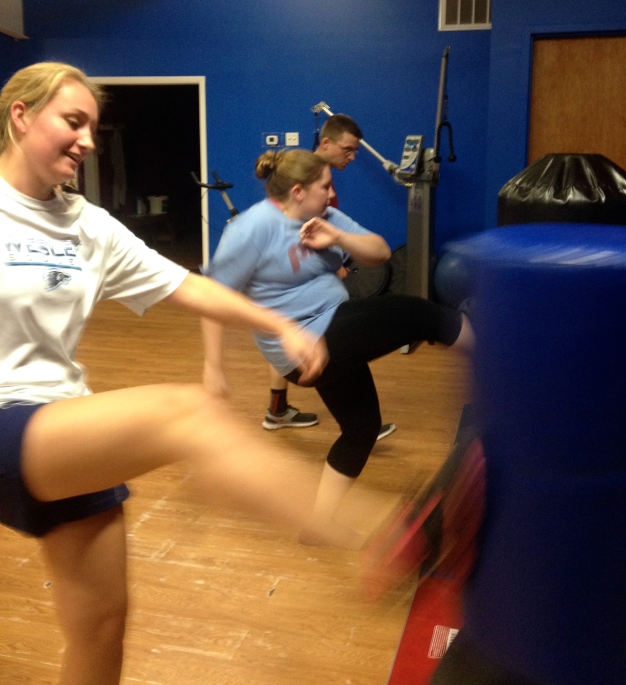 Some students working on their fitness and kick boxing skills.